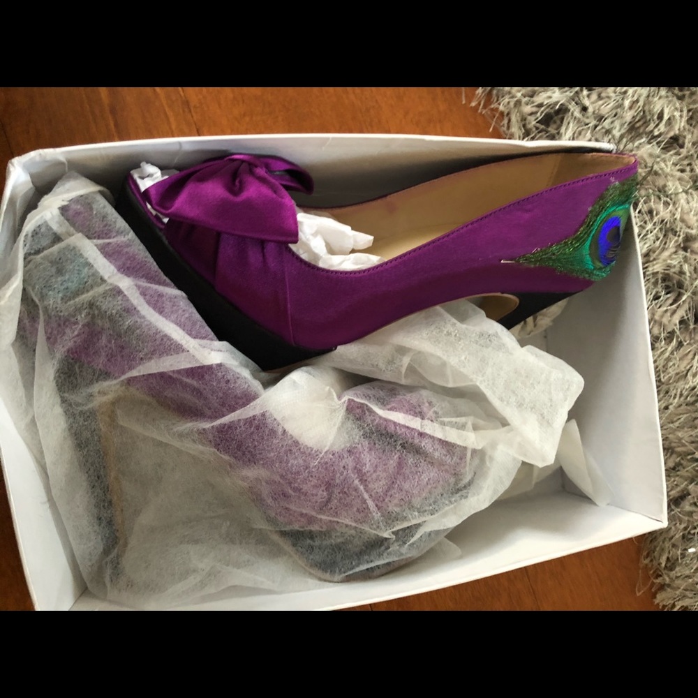 Purple with a beautiful peacock feather on side.